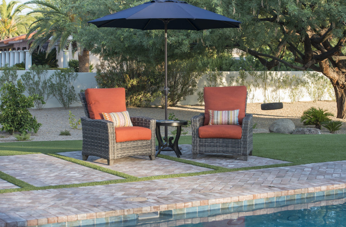 Two outdoor patio chairs by a pool