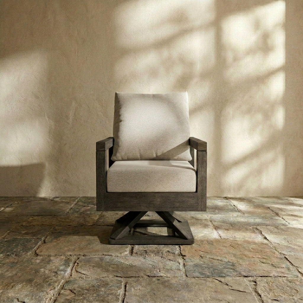 Contemporary dark timber patio swivel chair with plush cream cushions against a textured wall.