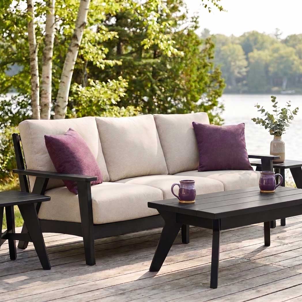 Comfortable Patriot patio sofa in black with plush light-colored cushions for outdoor lounging.