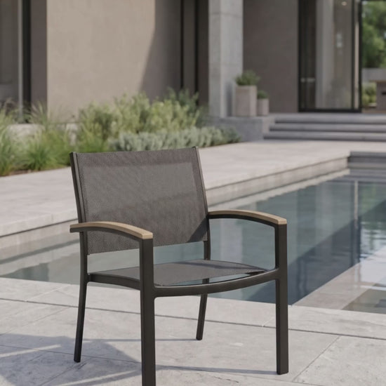 Black stackable sling club chair with a breathable mesh seat by Paddy O' Furniture