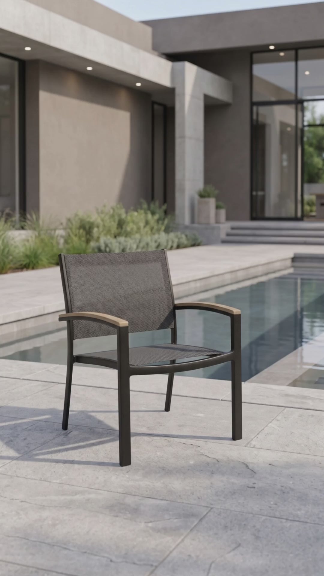 Black stackable sling club chair with a breathable mesh seat by Paddy O' Furniture
