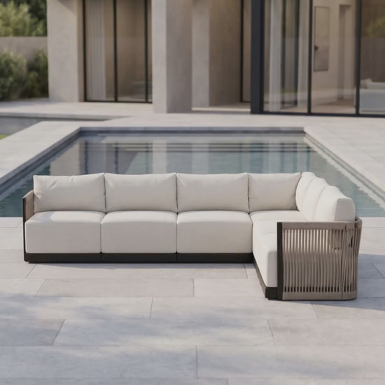 Paddy O' Furniture Resort 6-seat outdoor sectional sofa set with Bliss cushions on a patio.