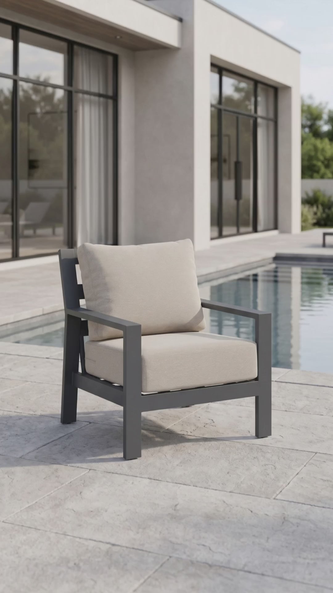 Peninsula club chair with gray aluminum frame and beige weather-resistant cushions