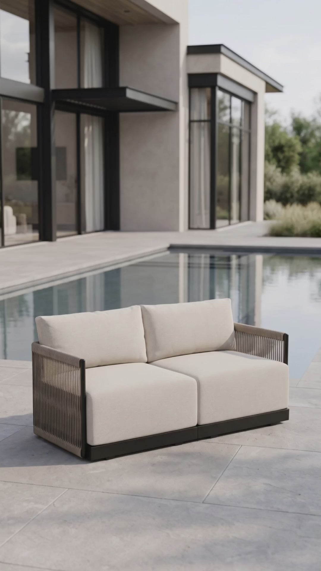 Paddy O' Furniture Resort loveseat featuring Bliss cushions on an outdoor terrace.
