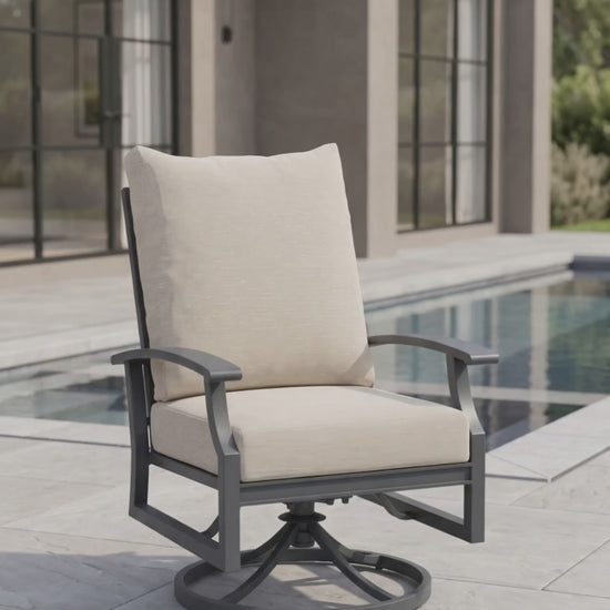Rockport outdoor dining swivel rocker with oatmeal cushions and a charcoal aluminum frame.