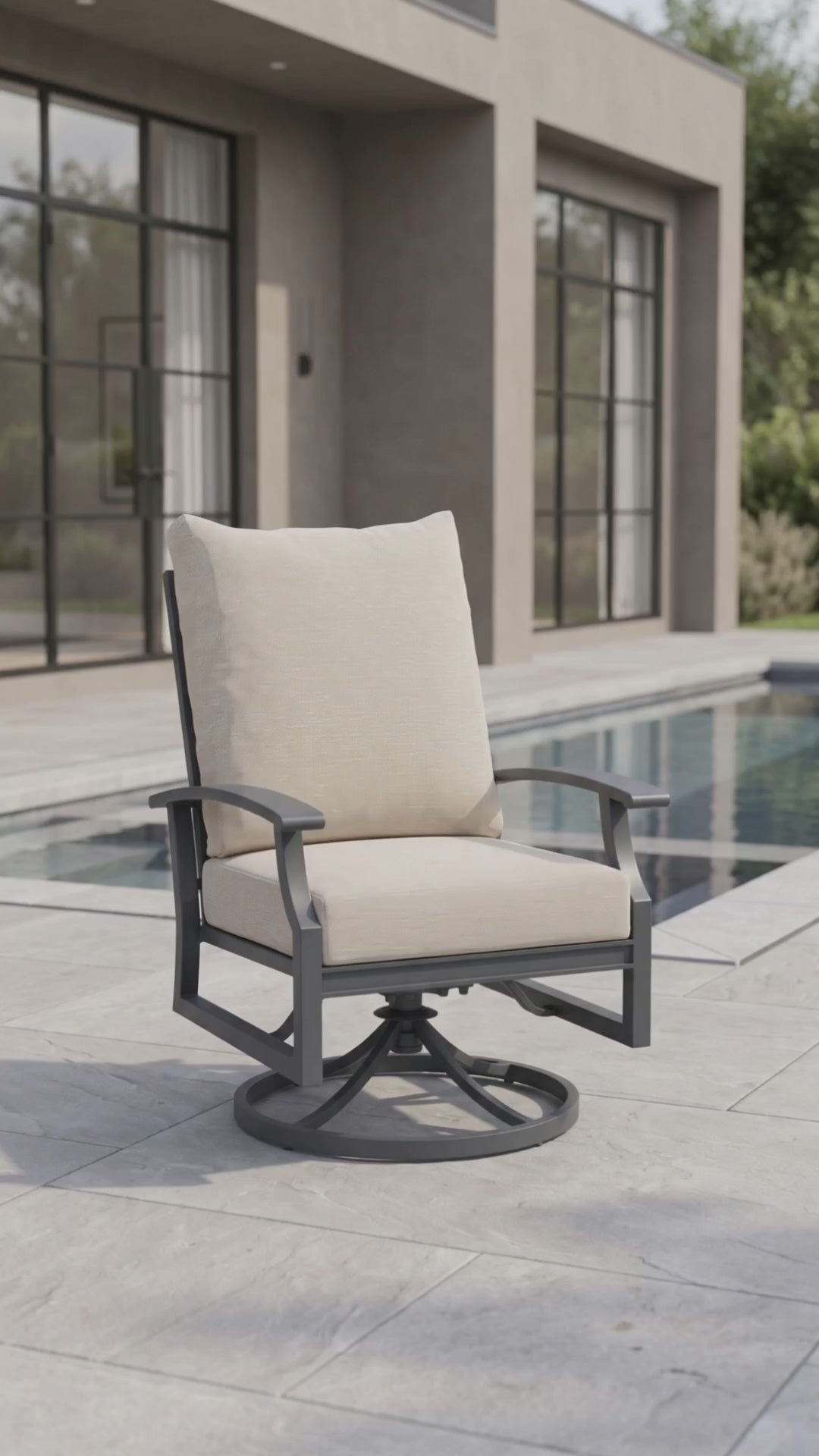 Rockport outdoor dining swivel rocker with oatmeal cushions and a charcoal aluminum frame.