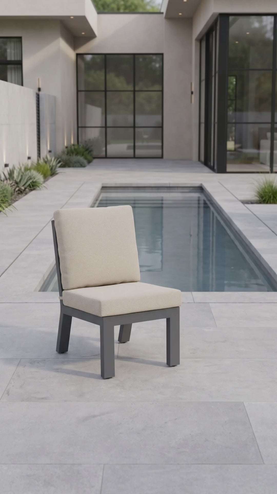 Peninsula armless outdoor dining chair with oatmeal cushions and a charcoal aluminum frame.