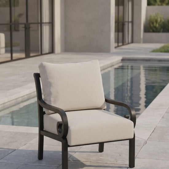 Club chair with scrolled arms and oatmeal bliss cushions.