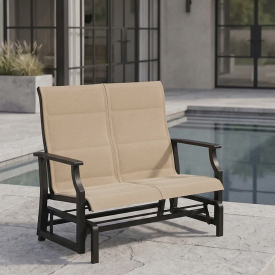 Paddy O' Furniture Newport padded sling double glider rocking on an outdoor patio.