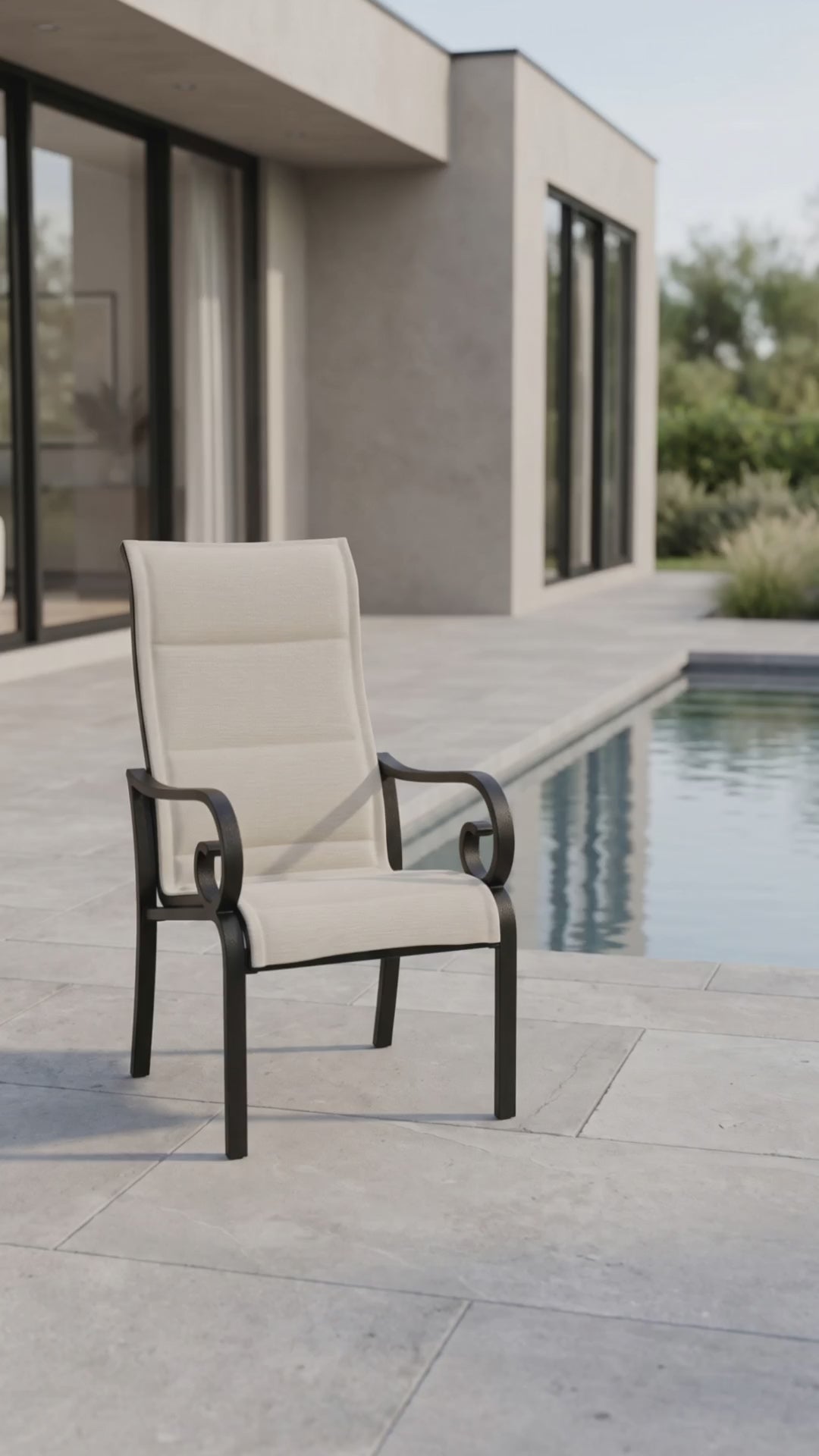 a traditional outdoor padded sling dining chair with scrolled arms