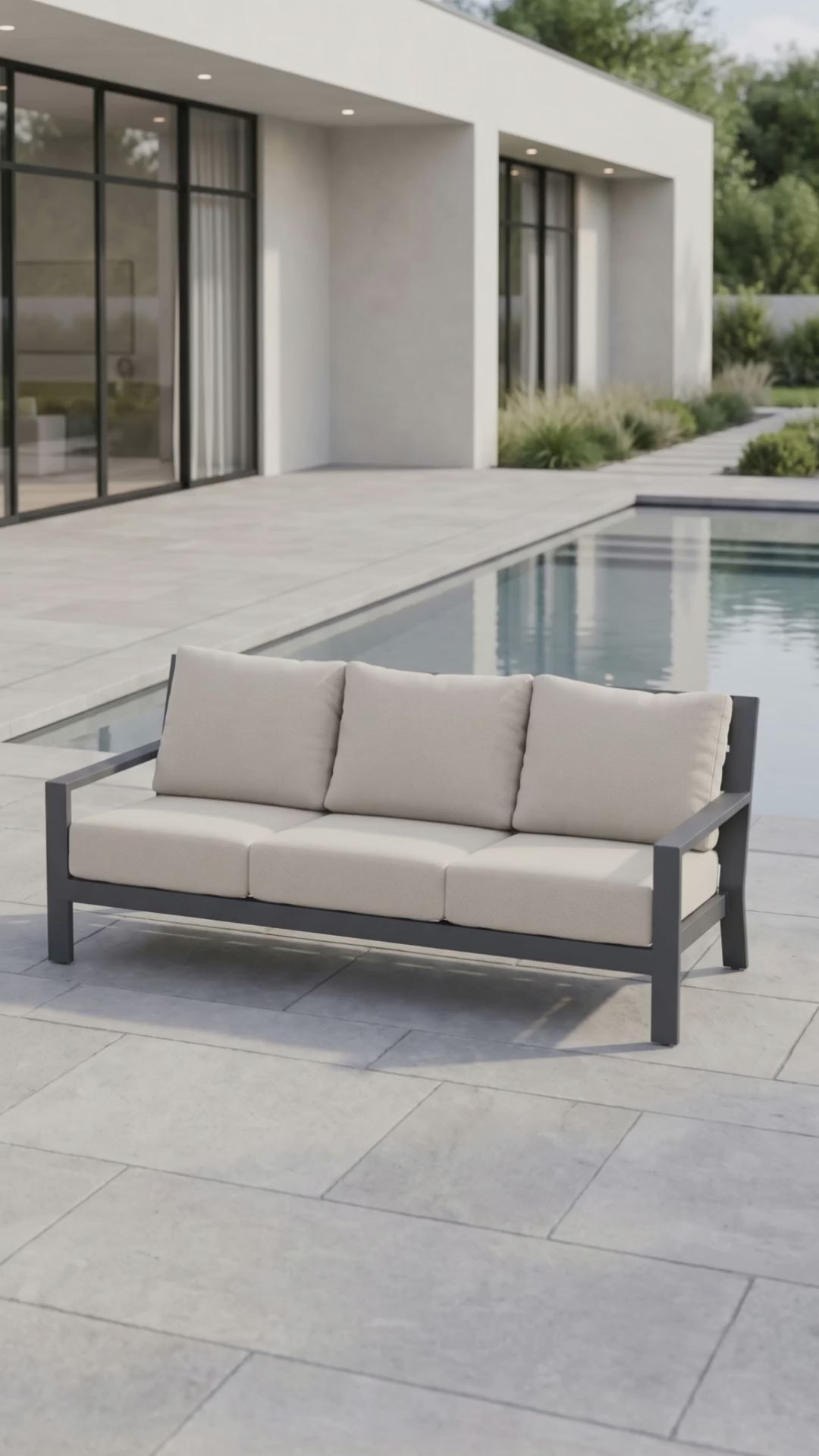 Paddy O' Furniture Peninsula outdoor sofa with Bliss cushions on a patio at sunset.
