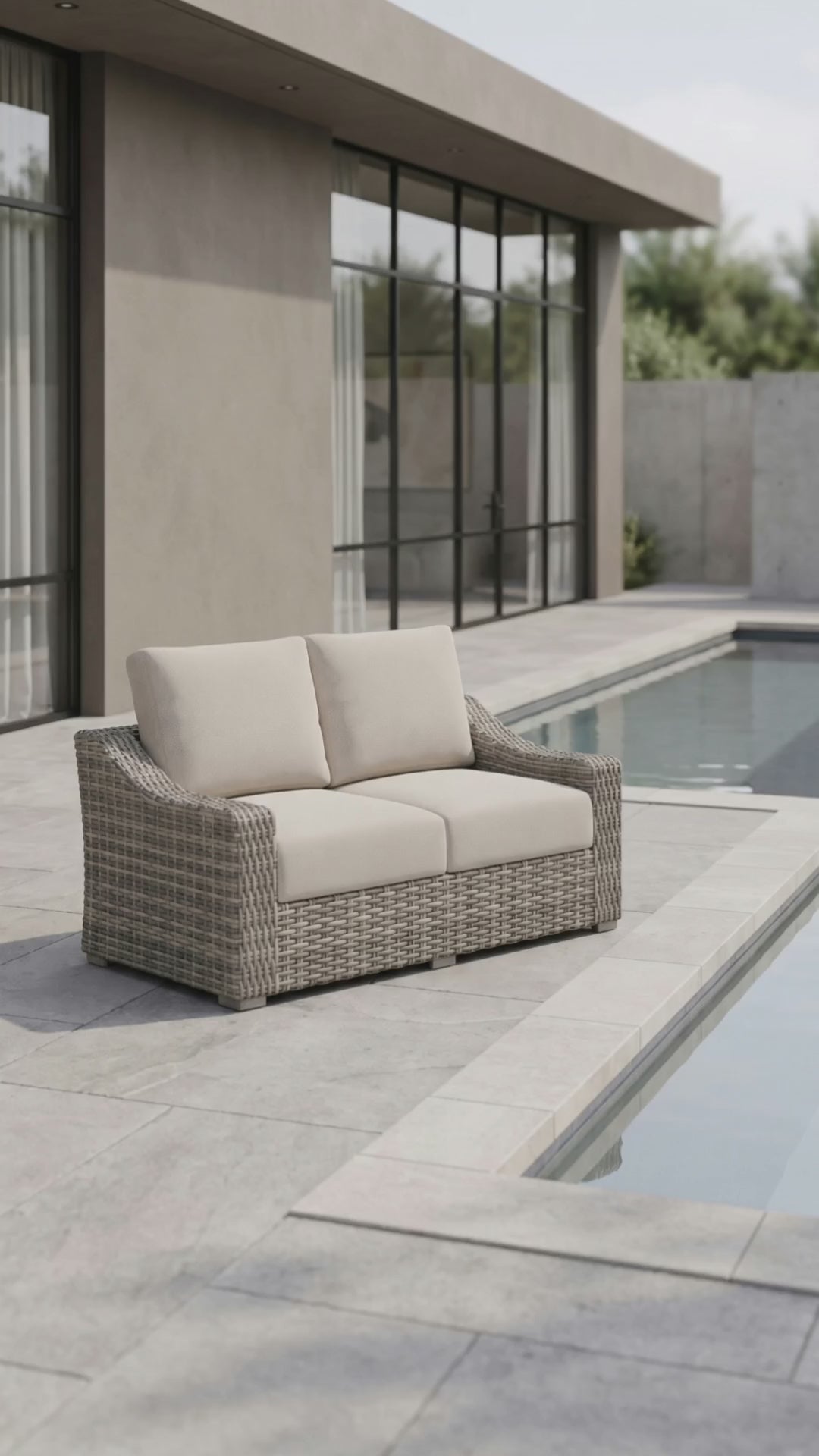 Paddy O' Furniture Loire Valley outdoor love seat with curved frame and plush cushions.