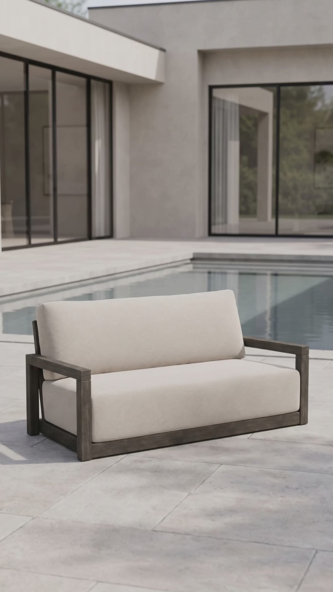 The Frame Loveseat by Paddy O' Furniture with plush Bliss cushions in a refined outdoor space.