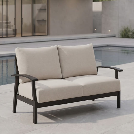 Paddy O' Furniture Newport outdoor loveseat with plush cushions for luxury patio relaxation.