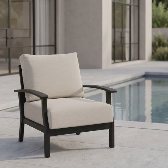 Newport outdoor club chair with oatmeal cushions and a black aluminum frame.