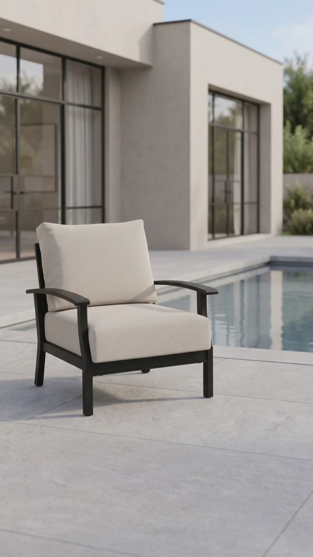 Newport outdoor club chair with oatmeal cushions and a black aluminum frame.